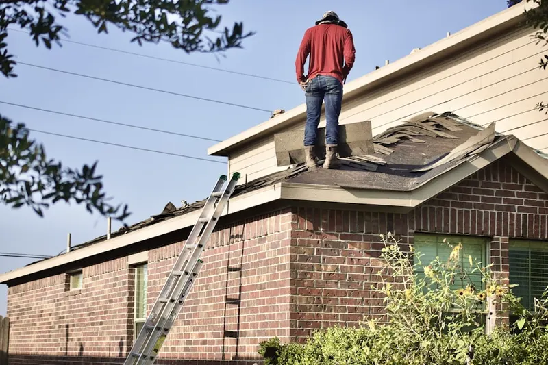 Professional roofer working on a residential roof in Aurora Woods